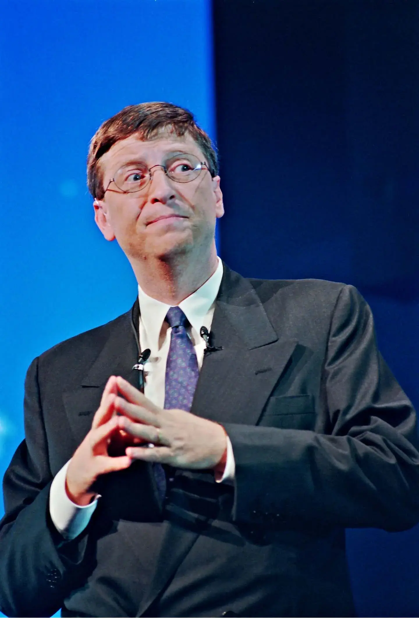 Bill Gates in a close portrait with hands together at a Paris internet seminar in 1998