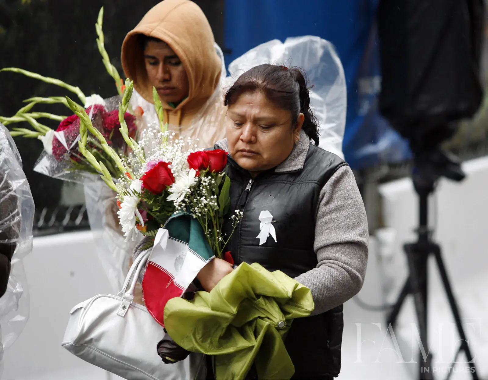 Two people carrying flowers at the September 11 anniversary ceremony in New York in 2009