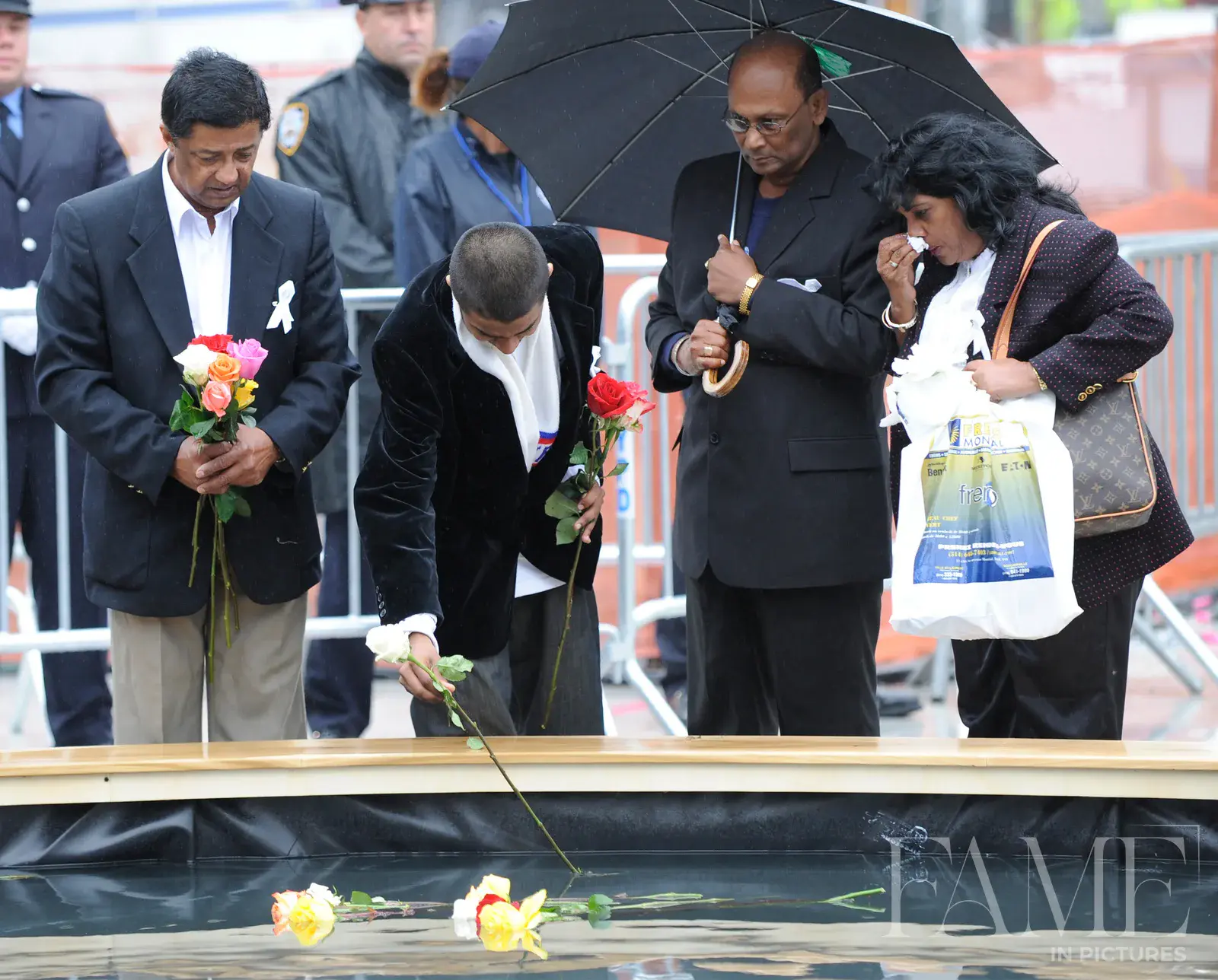 People placing flowers at the Ground Zero memorial ceremony in 2009