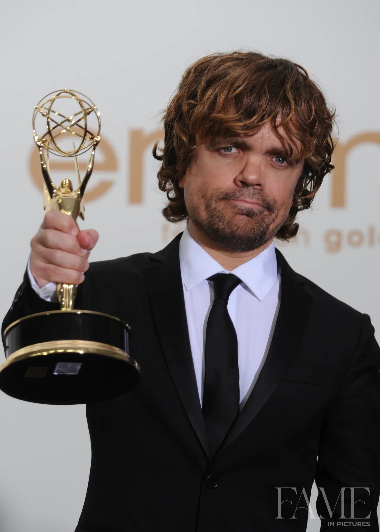 Peter Dinklage holding his Emmy award in Los Angeles in 2011