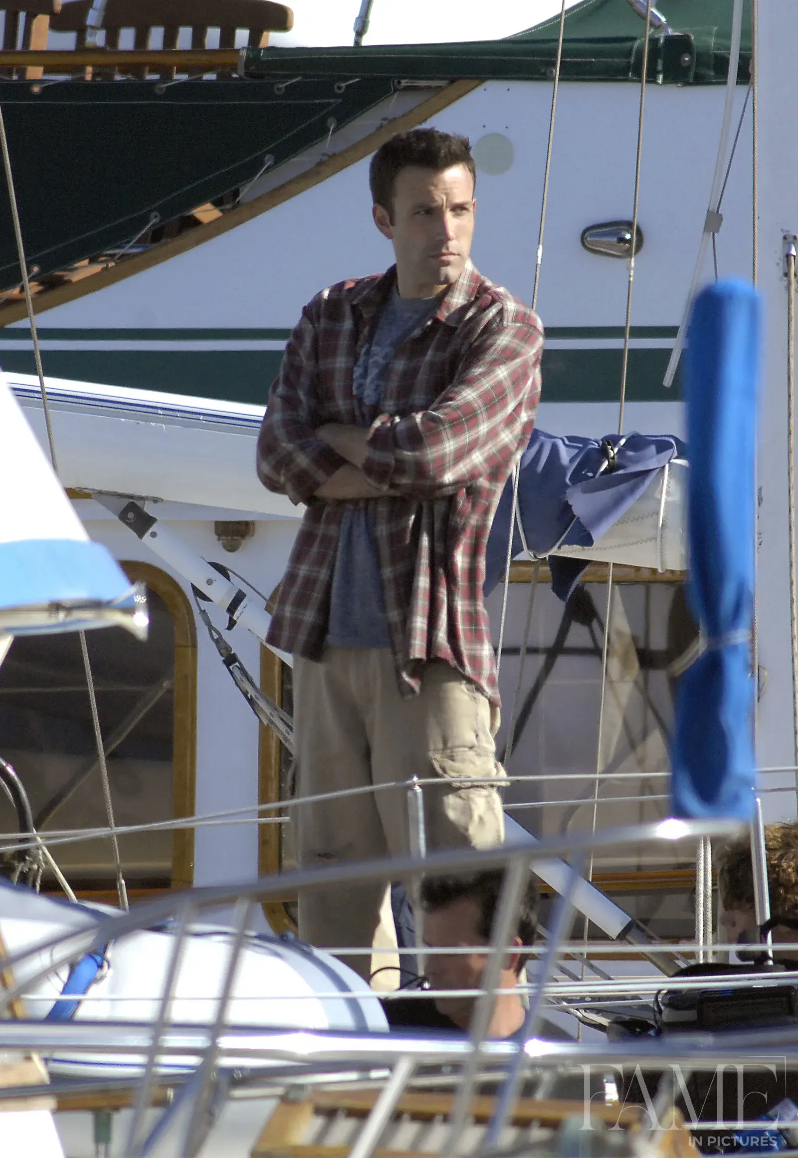 Ben Affleck standing beside boats on a Los Angeles film set in 2007