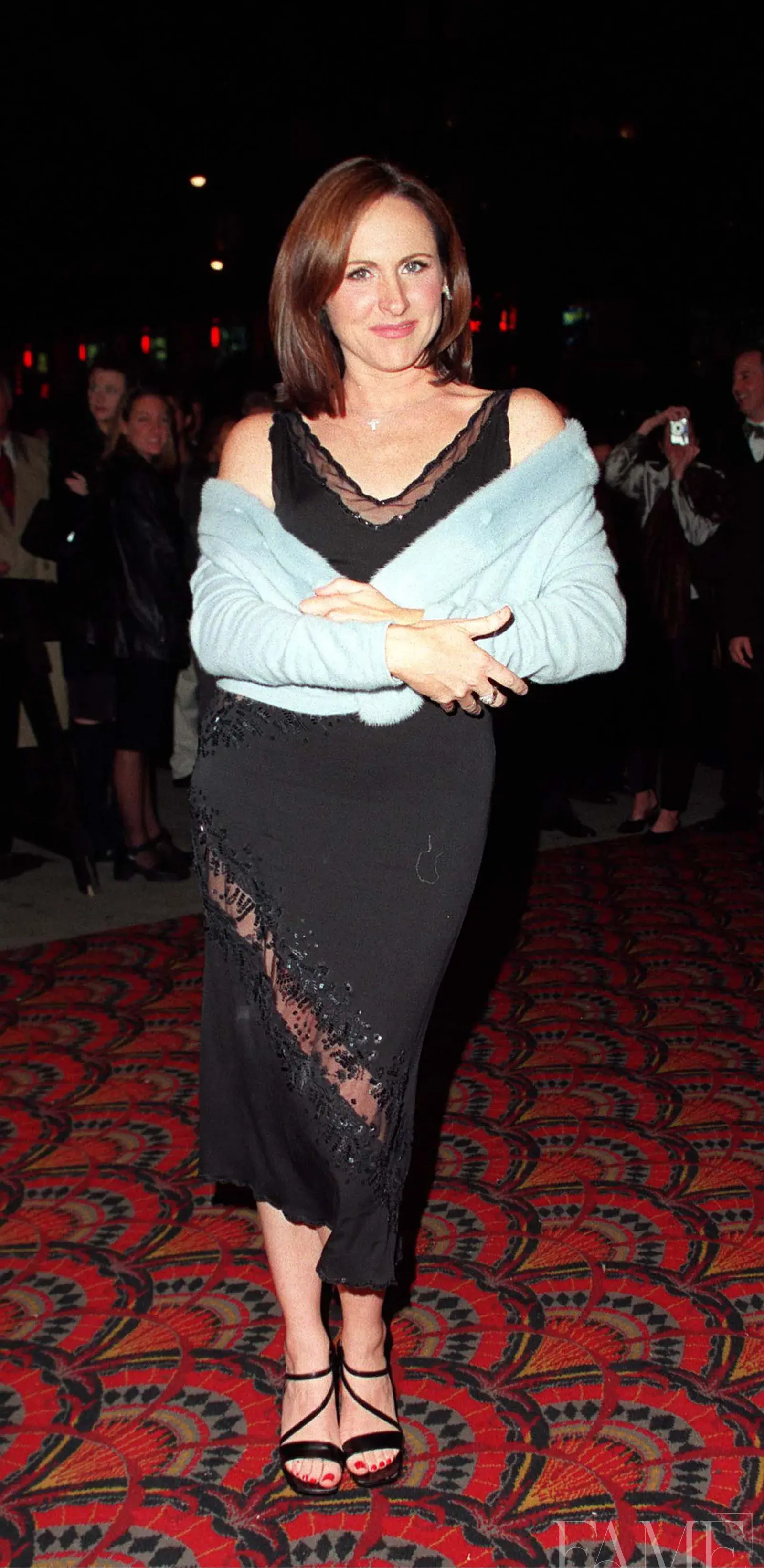 Molly Shannon wearing a black dress and pale blue wrap at the Superstar premiere in New York