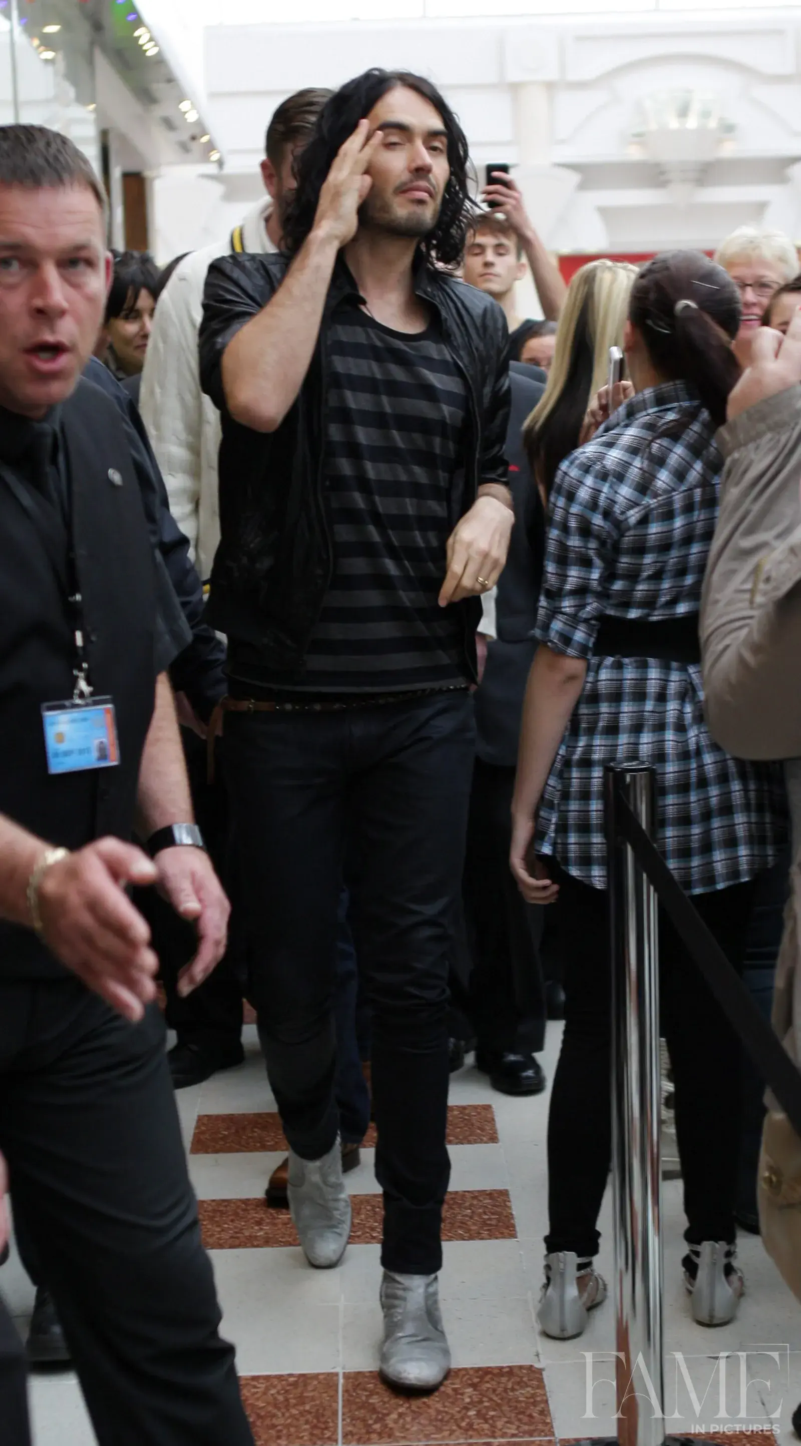 Russell Brand standing among attendees in the Merry Hill shopping centre during his 2010 book-signing appearance.