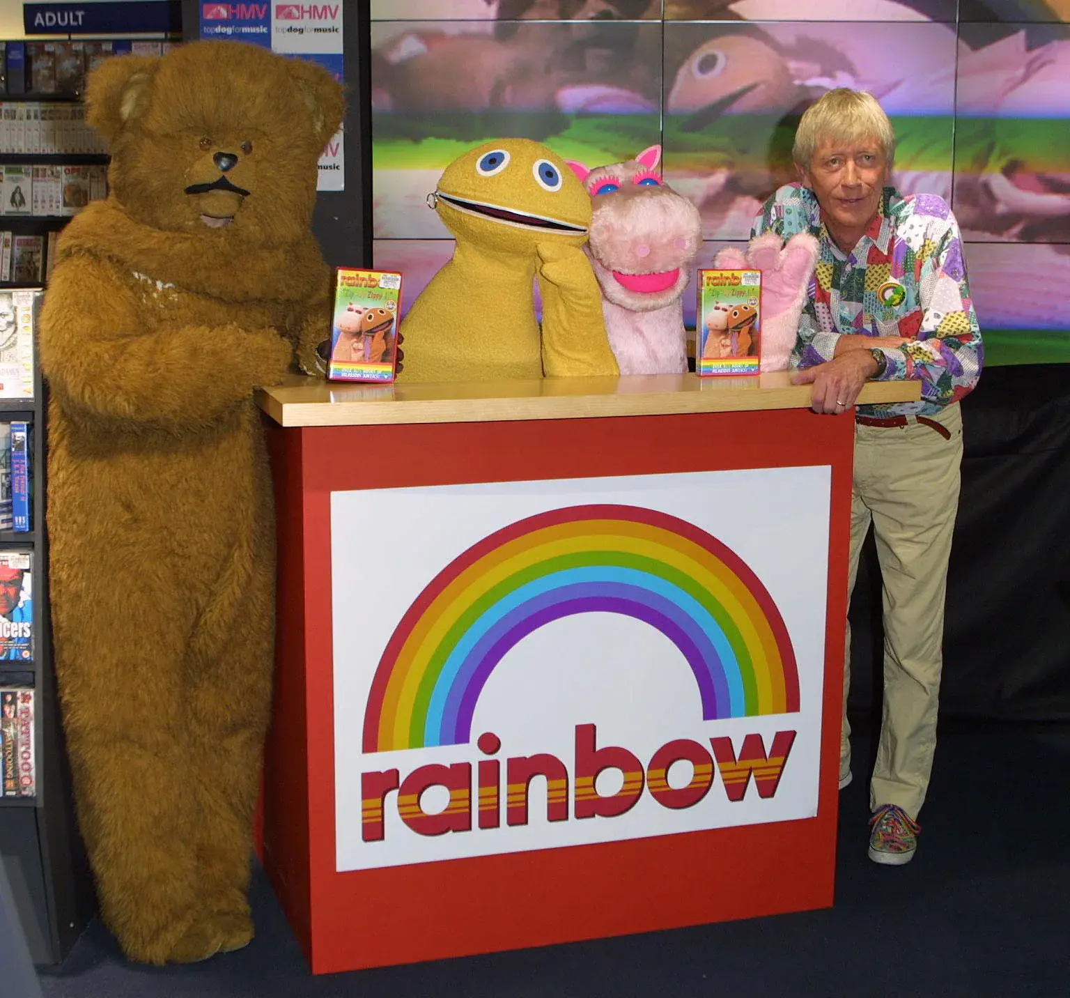 Bungle, Zippy, George and Geoffrey Hayes behind a Rainbow display at HMV Oxford Street