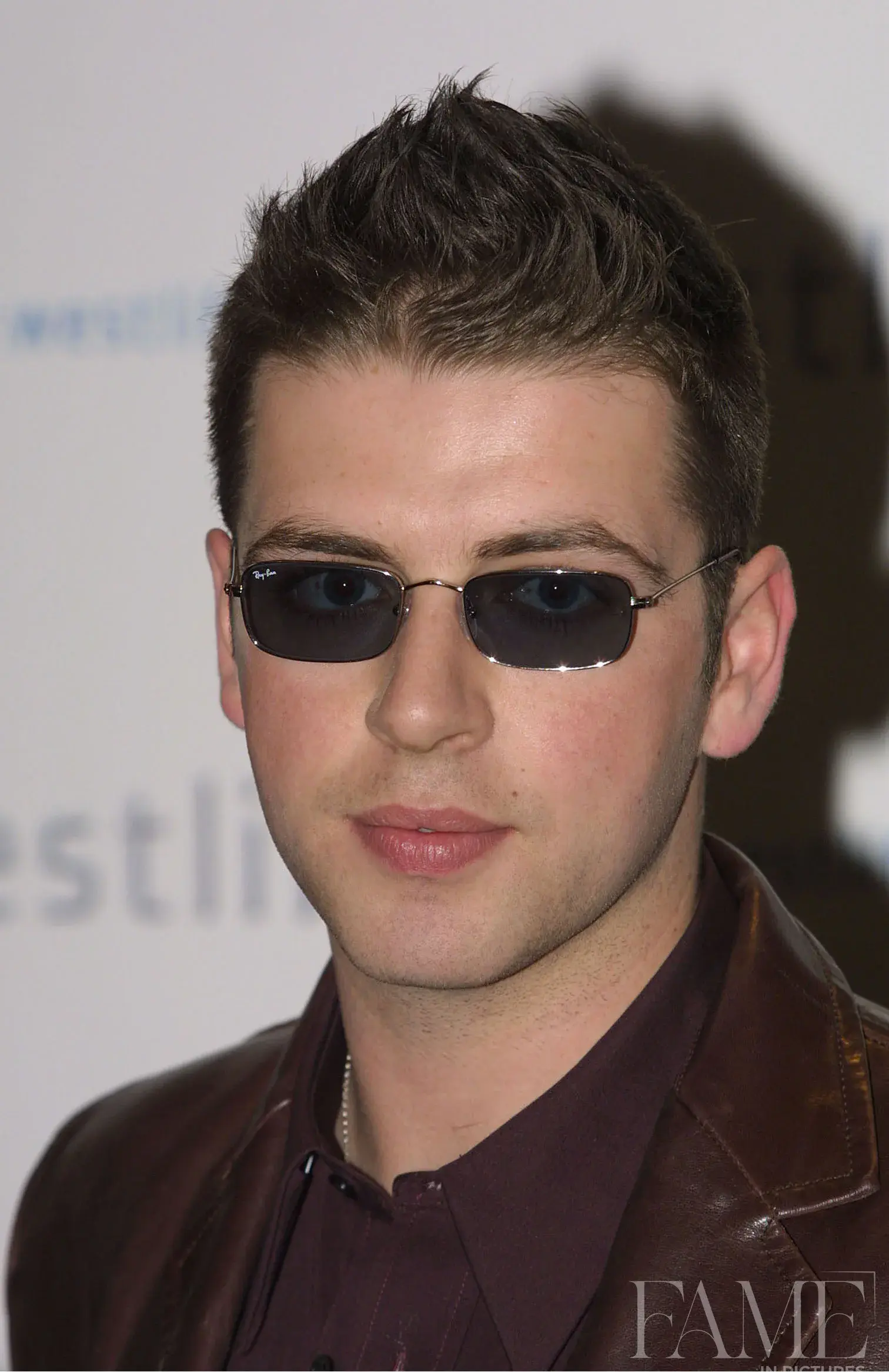 Mark Feehily wearing tinted glasses and a brown leather jacket at the album launch